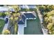 An aerial shot of a single Gathering home with a well manicured lawn, and a lengthy driveway at 267 Camrose St, Port Charlotte, FL 33954