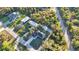 An aerial shot of a single Gathering home with a well manicured lawn, and a lengthy driveway at 267 Camrose St, Port Charlotte, FL 33954