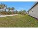 Expansive backyard with green grass, trees, and plenty of space for outdoor activities at 267 Camrose St, Port Charlotte, FL 33954