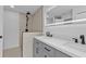 Modern bathroom featuring a tiled shower, double vanity with black hardware, and an illuminated mirror at 267 Camrose St, Port Charlotte, FL 33954