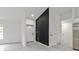 Bright entryway features gray tile flooring, white walls, black accent wall, and a contemporary design at 267 Camrose St, Port Charlotte, FL 33954