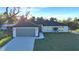 Beautiful single Gathering home featuring lush green lawns, a two car garage, and immaculate landscaping at 267 Camrose St, Port Charlotte, FL 33954