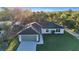 Beautiful single Gathering home featuring lush green lawns, a two car garage, and immaculate landscaping at 267 Camrose St, Port Charlotte, FL 33954