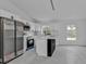 Modern kitchen with stainless steel appliances, center island and stylish lighting at 267 Camrose St, Port Charlotte, FL 33954