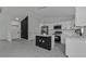 Open floor plan showcases a kitchen with island, modern appliances, and dark wood accents at 267 Camrose St, Port Charlotte, FL 33954
