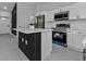 Modern kitchen features island with seating, stainless appliances, and sleek countertops at 267 Camrose St, Port Charlotte, FL 33954