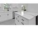 Bright kitchen featuring white cabinets, matte black hardware, light countertops and stainless steel appliances at 267 Camrose St, Port Charlotte, FL 33954