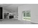 Open concept living space with modern tile floors, a sleek kitchen, and bright sliding glass doors at 267 Camrose St, Port Charlotte, FL 33954