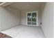 Covered patio with concrete flooring, offering a cozy outdoor living space and sliding glass doors at 267 Camrose St, Port Charlotte, FL 33954