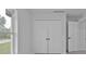 Bright room featuring double doors, a window, and white trim at 267 Camrose St, Port Charlotte, FL 33954