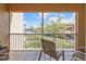 Relaxing balcony with views of manicured lawns and a serene lake at 3322 Purple Martin Dr # 127, Punta Gorda, FL 33950