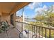 Balcony with cozy chairs and a table offers views of the marina and greenery at 3322 Purple Martin Dr # 127, Punta Gorda, FL 33950