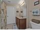 Bathroom showcasing a wood vanity, a white toilet, and a shower curtain with a tropical palm tree design at 3322 Purple Martin Dr # 127, Punta Gorda, FL 33950