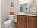 Cozy bathroom features a toilet, sink, and wood-toned vanity at 3322 Purple Martin Dr # 127, Punta Gorda, FL 33950