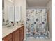 Bathroom featuring seaside themed shower curtain, tile floor and wood vanity at 3322 Purple Martin Dr # 127, Punta Gorda, FL 33950