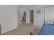 Cozy bedroom featuring neutral walls and carpet, with an open doorway revealing additional living space at 3322 Purple Martin Dr # 127, Punta Gorda, FL 33950