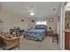 Bedroom with wicker chair, wood furniture, floral bedspread, and a view into the bathroom at 3322 Purple Martin Dr # 127, Punta Gorda, FL 33950