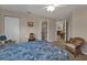 Cozy bedroom featuring a floral bedspread, wicker chair, and attached bathroom at 3322 Purple Martin Dr # 127, Punta Gorda, FL 33950