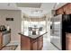 Well-lit kitchen with an island, tile floors, stainless steel appliances, and a view from the breakfast nook at 3322 Purple Martin Dr # 127, Punta Gorda, FL 33950