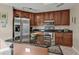 Open kitchen with dark wood cabinetry, granite counters, and stainless appliances at 3322 Purple Martin Dr # 127, Punta Gorda, FL 33950