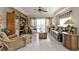 Bright living room with neutral tile flooring, ceiling fan, and sliding doors to the balcony at 3322 Purple Martin Dr # 127, Punta Gorda, FL 33950
