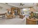 Living room featuring tile flooring, ceiling fan, entertainment center, and sliding doors to the balcony at 3322 Purple Martin Dr # 127, Punta Gorda, FL 33950