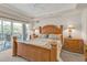 Bedroom boasts a large bed and slider to a balcony with beautiful views at 3322 Purple Martin Dr # 127, Punta Gorda, FL 33950