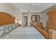 Bedroom features a large bed and a wooden dresser with a mirror at 3322 Purple Martin Dr # 127, Punta Gorda, FL 33950