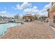 Community pool area features a cabana with seating and BBQ, with dock views at 3322 Purple Martin Dr # 127, Punta Gorda, FL 33950