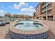 Community pool and hot tub with brick pavers, surrounded by a privacy fence at 3322 Purple Martin Dr # 127, Punta Gorda, FL 33950