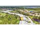 Beautiful aerial of townhome community, featuring water views, mature trees, and immaculate landscaping at 3393 Grand Vista Ct # 101, Port Charlotte, FL 33953