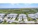 Stunning aerial view of townhomes with lush landscaping, golf course, and serene water views at 3393 Grand Vista Ct # 101, Port Charlotte, FL 33953