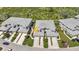 Overhead shot of townhomes with well-manicured lawns, driveways, and tropical landscaping at 3393 Grand Vista Ct # 101, Port Charlotte, FL 33953