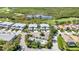 Panoramic aerial view of a community with a pool, golf course, lake and well-maintained landscaping at 3393 Grand Vista Ct # 101, Port Charlotte, FL 33953