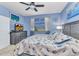 Cozy bedroom with blue walls, a king-sized bed, wooden furnishings, and ample natural light at 3393 Grand Vista Ct # 101, Port Charlotte, FL 33953