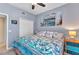 Bedroom with ceiling fan, closet, beach decor, and bedside table with lamp at 3393 Grand Vista Ct # 101, Port Charlotte, FL 33953