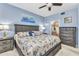 Comfortable bedroom with blue walls, a king-sized bed, and stylish coastal decor at 3393 Grand Vista Ct # 101, Port Charlotte, FL 33953