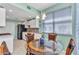 Dining area features a stylish table and chairs adjacent to bright kitchen at 3393 Grand Vista Ct # 101, Port Charlotte, FL 33953
