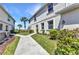 A well-maintained walkway and landscaped garden leading to the front entrance of the townhome at 3393 Grand Vista Ct # 101, Port Charlotte, FL 33953