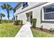 Exterior facade featuring a front entrance with manicured landscaping and a charming pathway at 3393 Grand Vista Ct # 101, Port Charlotte, FL 33953