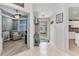 Hallway leading to the office, kitchen, and front door with tile floors at 3393 Grand Vista Ct # 101, Port Charlotte, FL 33953