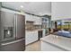 Bright kitchen featuring stainless steel appliances, white cabinetry and easy access to the lanai at 3393 Grand Vista Ct # 101, Port Charlotte, FL 33953