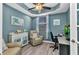 Office with blue walls, wood floors, ceiling fan, chair, desk, and window at 3393 Grand Vista Ct # 101, Port Charlotte, FL 33953