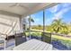 Screened patio with furniture offering views of lush landscaping at 3393 Grand Vista Ct # 101, Port Charlotte, FL 33953