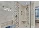 Modern shower with designer tile, built-in niche, seating, and sleek fixtures in a stylish bathroom at 3393 Grand Vista Ct # 101, Port Charlotte, FL 33953