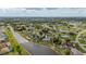 An aerial shot of a waterfront home with a screened-in pool, set among other homes at 380 Concordia St, Punta Gorda, FL 33983