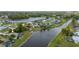 An aerial view of a canal-front property with a screened lanai in a residential area at 380 Concordia St, Punta Gorda, FL 33983