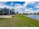 A backyard with a peaceful lake view and lush green lawn, perfect for outdoor relaxation at 380 Concordia St, Punta Gorda, FL 33983