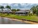 A beautiful waterfront property with a screened-in lanai and lush green lawn at 380 Concordia St, Punta Gorda, FL 33983