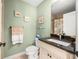 Cozy bathroom with framed art, a toilet, a sink with granite countertop, and a shower at 380 Concordia St, Punta Gorda, FL 33983